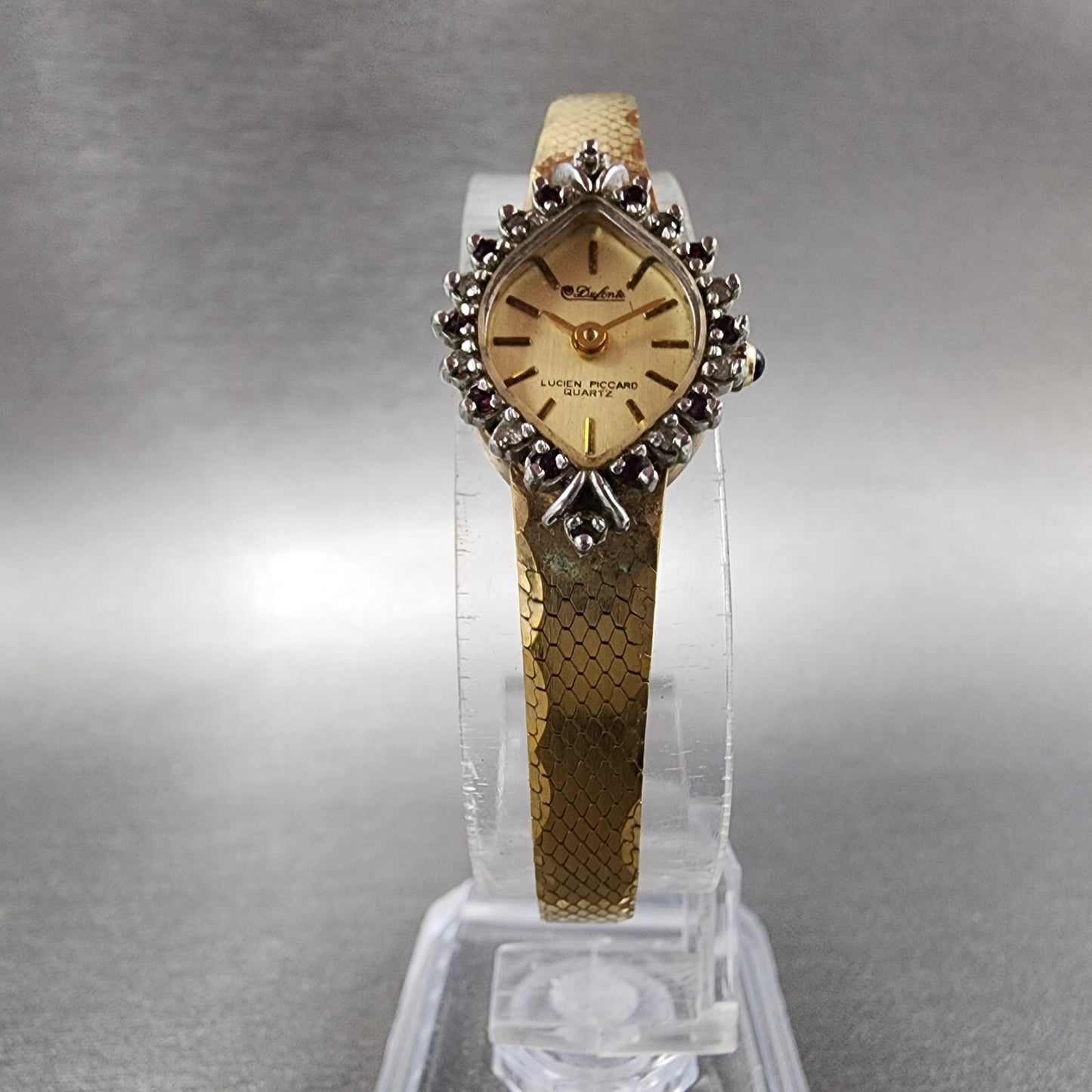 Lucien Piccard Dufonte Watch Women 14mm Champagne Dial Gold Tone Ruby Bezel Runs