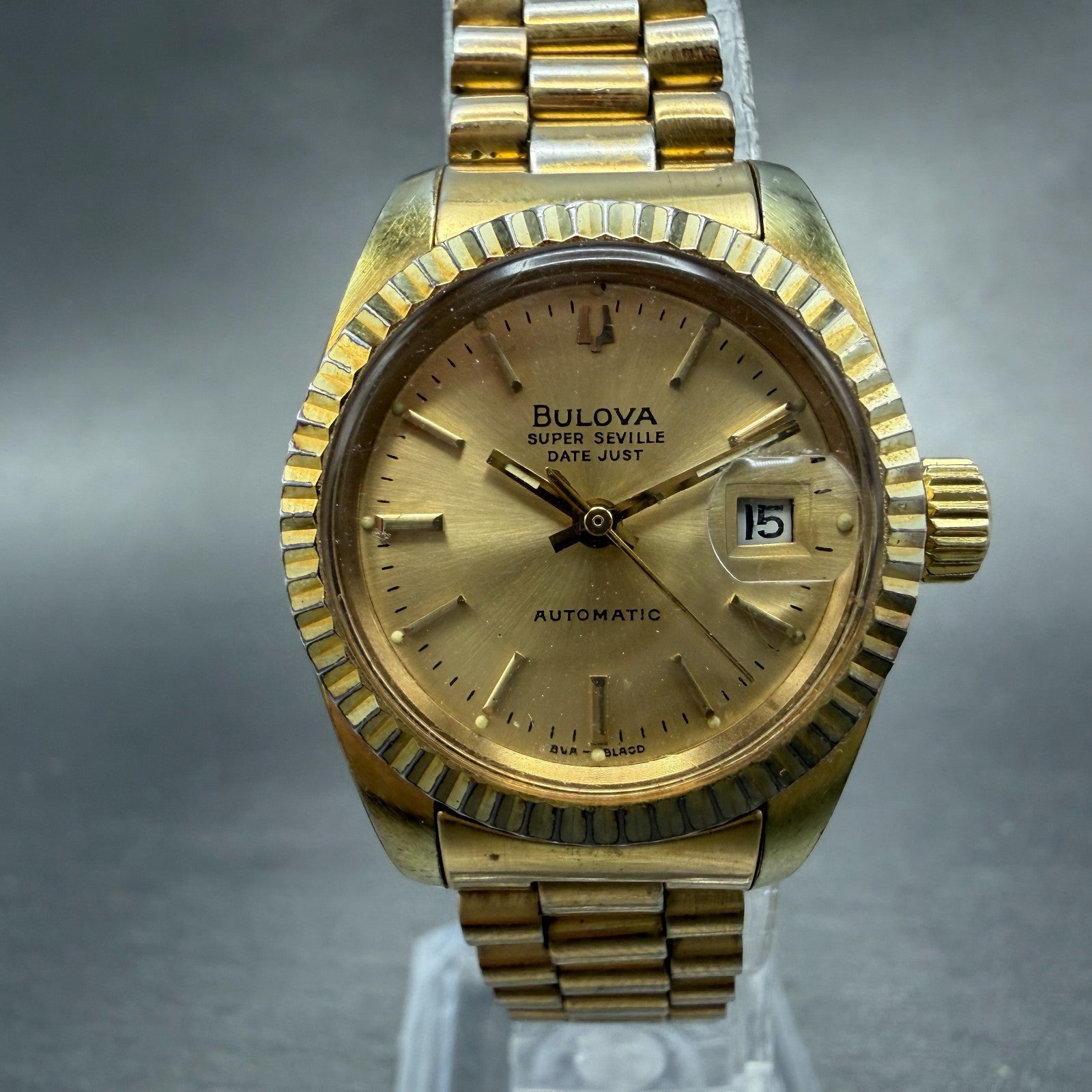 Bulova Super Seville Date Just Watch Women 26mm Gold Dial Gold Tone Automatic A10
