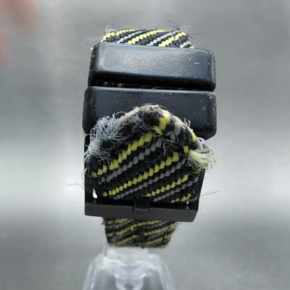 Frayed black, yellow, and gray striped nylon watch strap with black buckle on display.