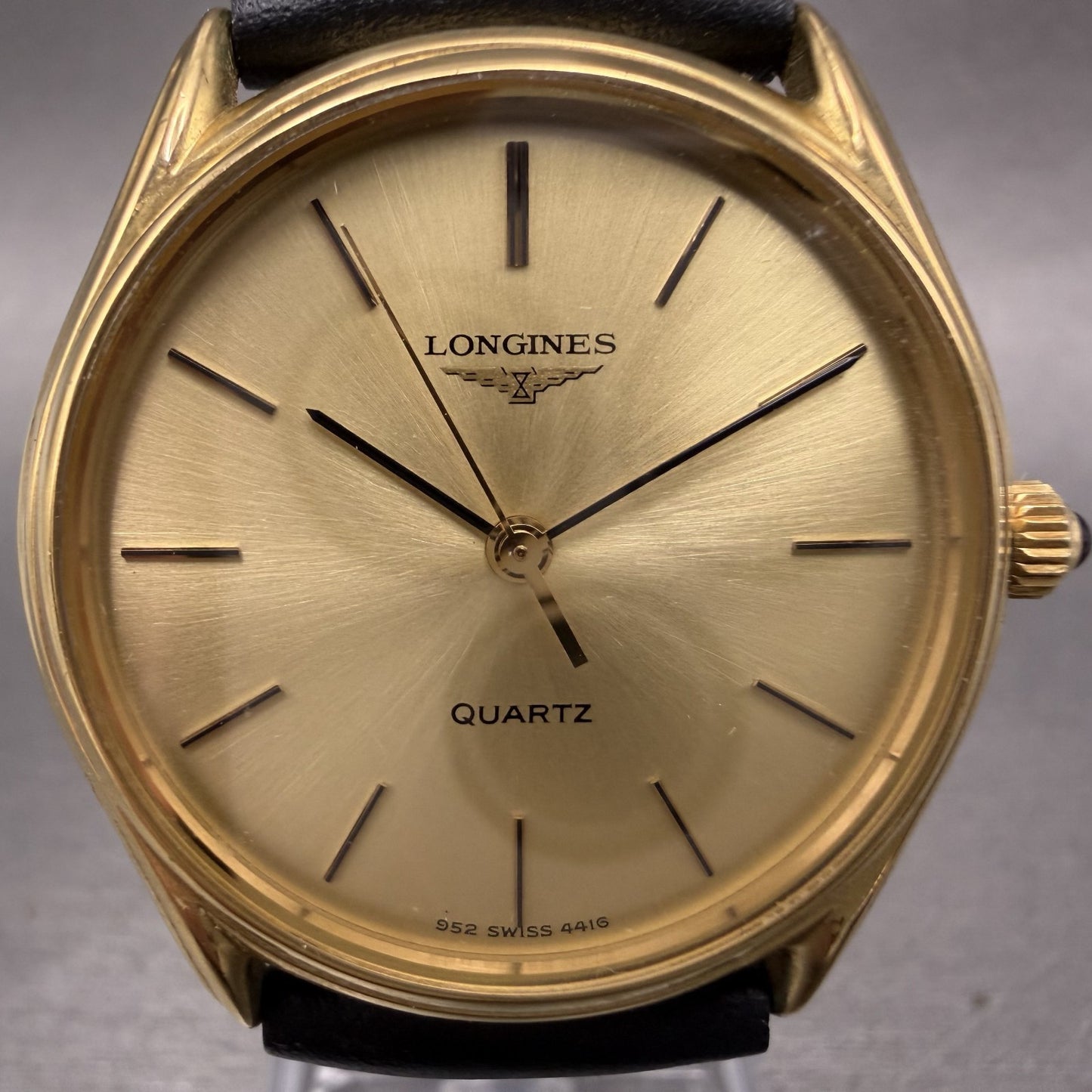 Longines gold quartz watch with minimal dial and black leather strap
