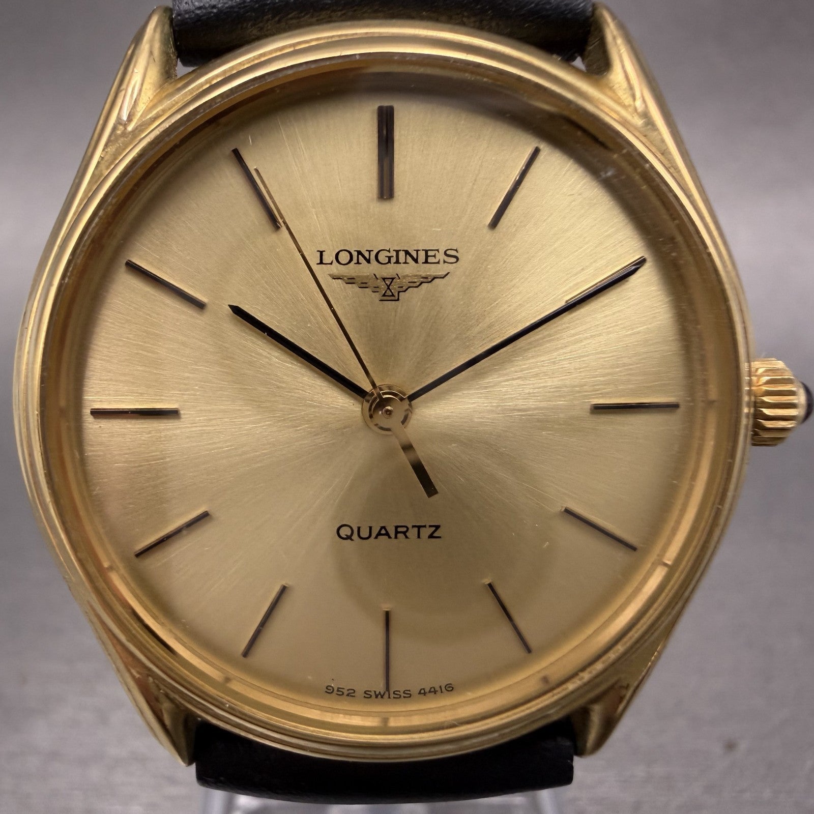 Longines gold quartz watch with minimal dial and black leather strap