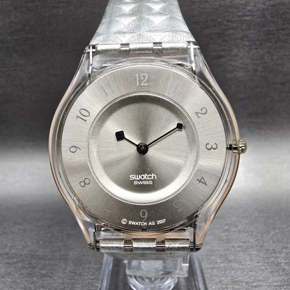 Swatch Skin Facet Glam Watch Women 34mm Silver Dial Clear Case SFK312 New Batt0