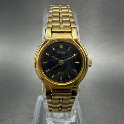 Seiko SX Watch Women 19mm Black Dial Gold Tone Round V4010091 New Battery0