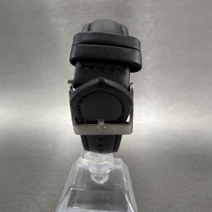 Black leather watch strap with silver buckle on clear display stand
