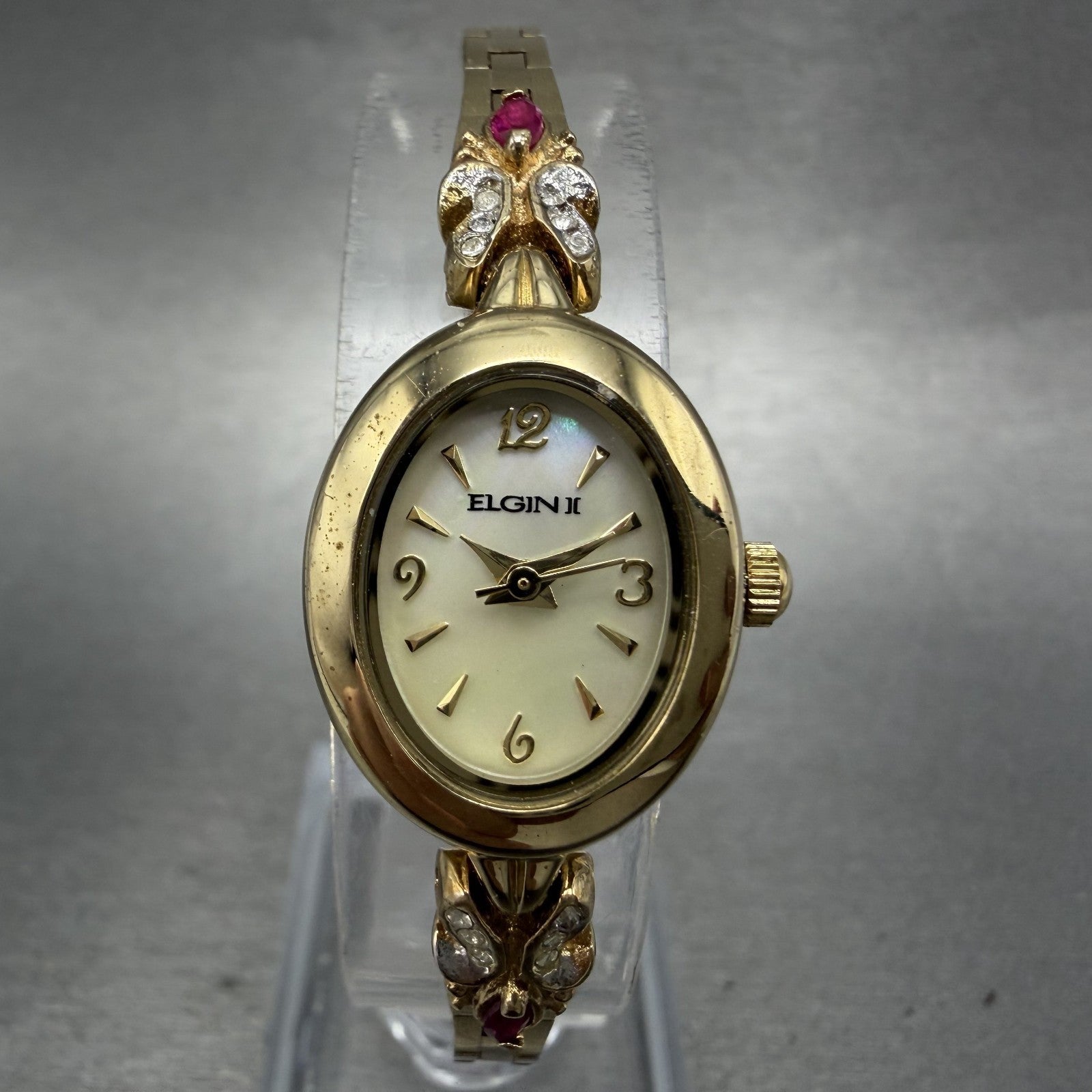 Elgin Watch Women 18mm MOP Dial Gold Tone Oval Ruby Diamond Bezel New Battery0