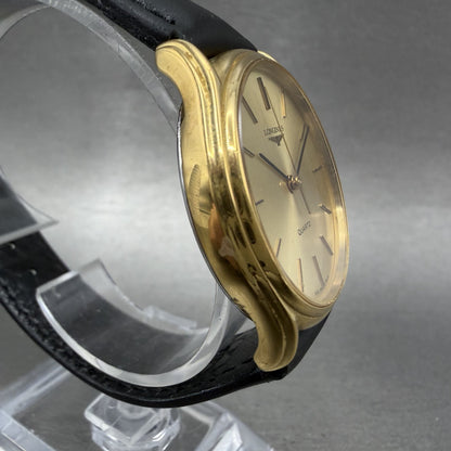 Longines gold-tone quartz wristwatch with black leather strap, minimalist dial, side view