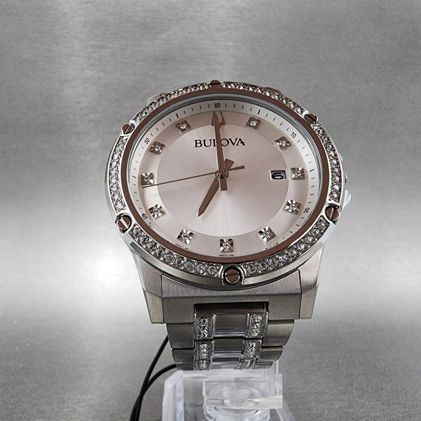 Bulova women's silver-tone watch with crystal accents and date display on a metallic band