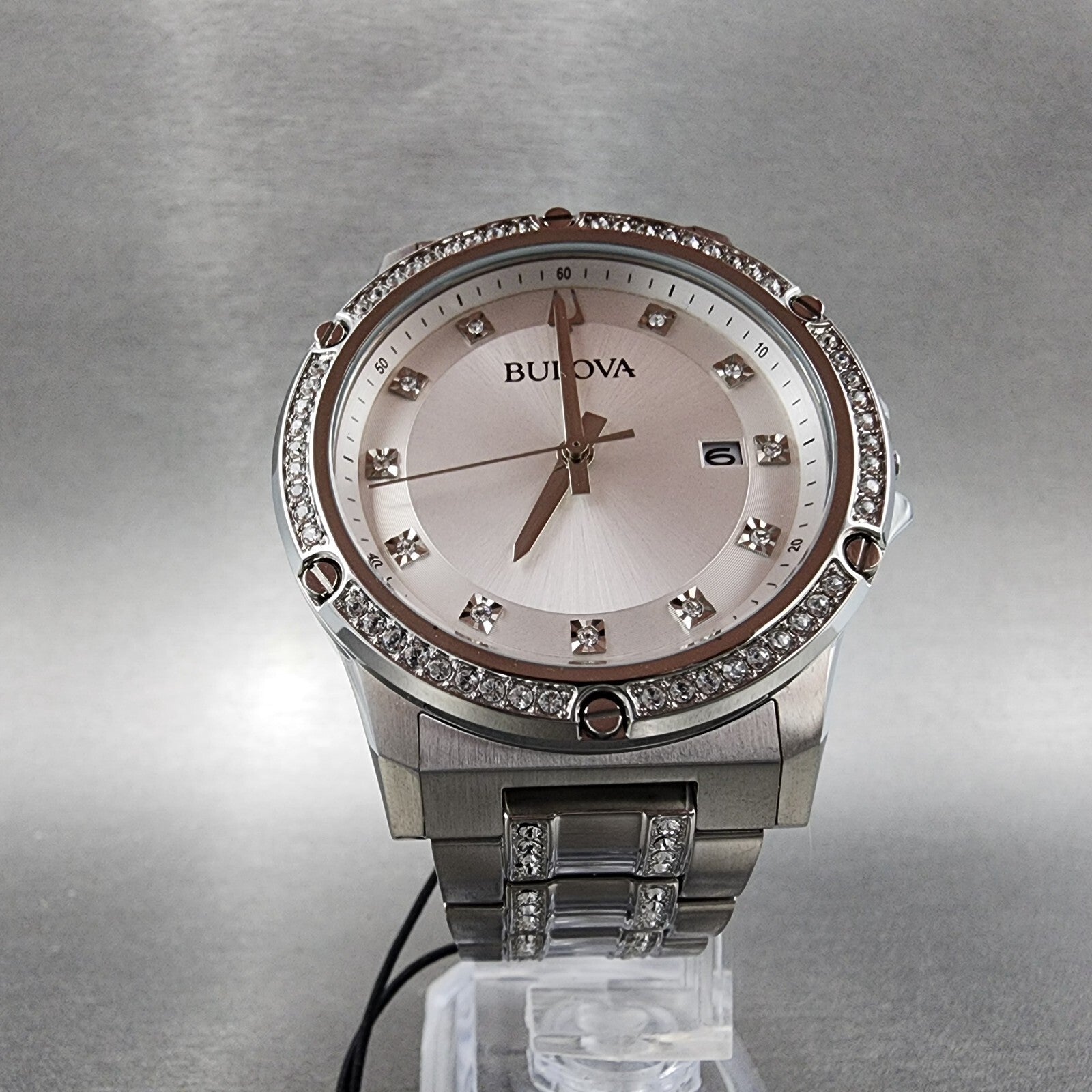 Bulova women's silver-tone watch with crystal accents and date display on a metallic band