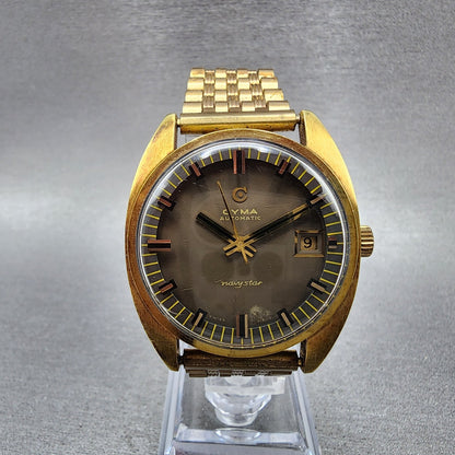 Cyma Navy Star Watch Men 35mm Brown Dial Gold Tone Date Automatic Cushion Runs