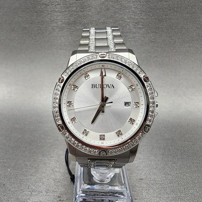 Bulova silver wristwatch with crystal accents, stainless steel band, and date display on stand