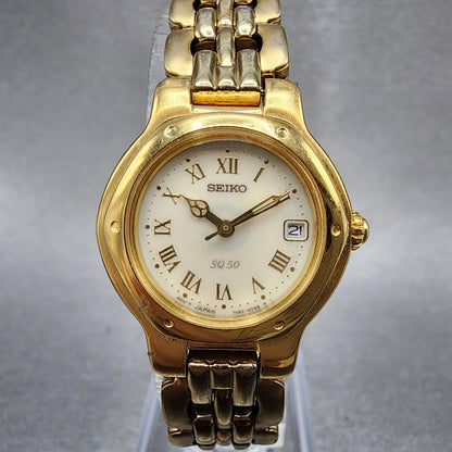 Seiko SQ 50 Watch Women 25mm White Dial Gold Tone Date Round 7N826C53 New Batt0