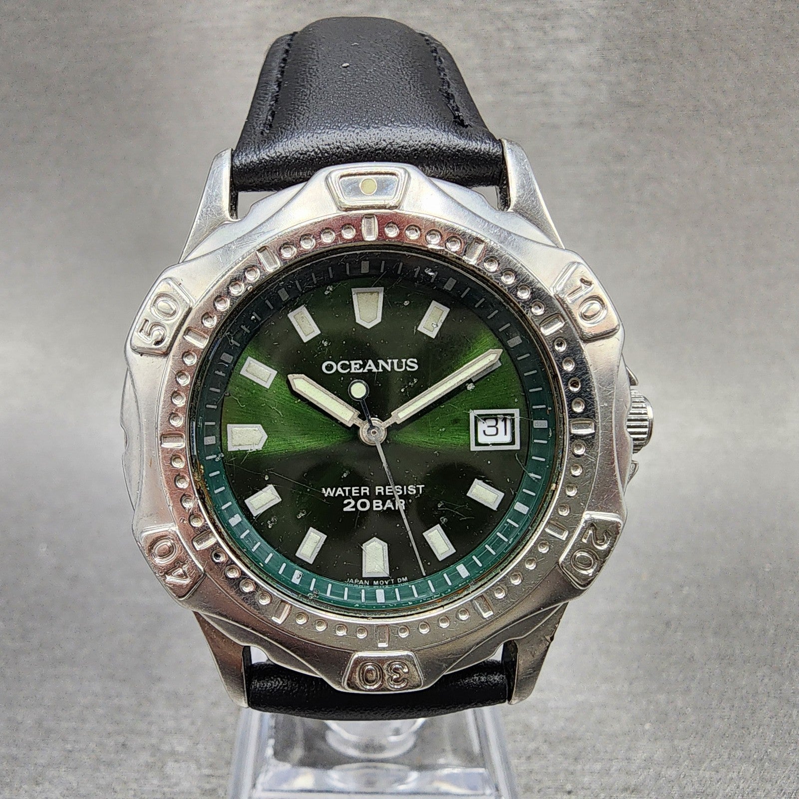 Oceanus diver watch with green dial, date display, black leather strap, silver bezel
