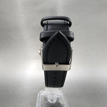Black leather watch strap with silver buckle on display stand, grey background