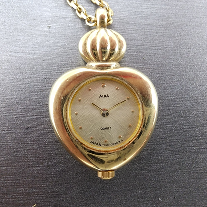 Alba Heart Necklace Watch Women 20mm Champagne Dial Gold Tone Y150-0B20 New Batt