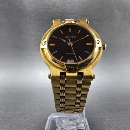 Gruen Watch Unisex 31mm Black Dial Gold Tone Date Round 225-6M12 New Battery6