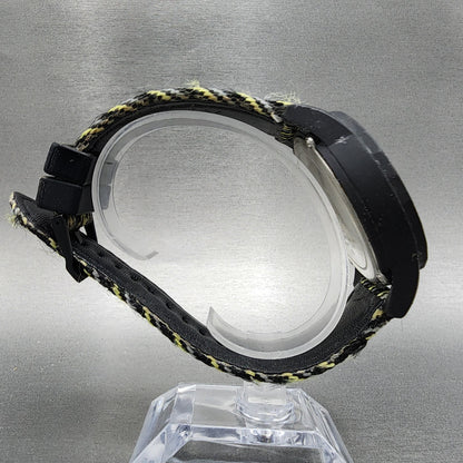 Black and yellow fabric strap wristwatch with plastic case on clear display stand