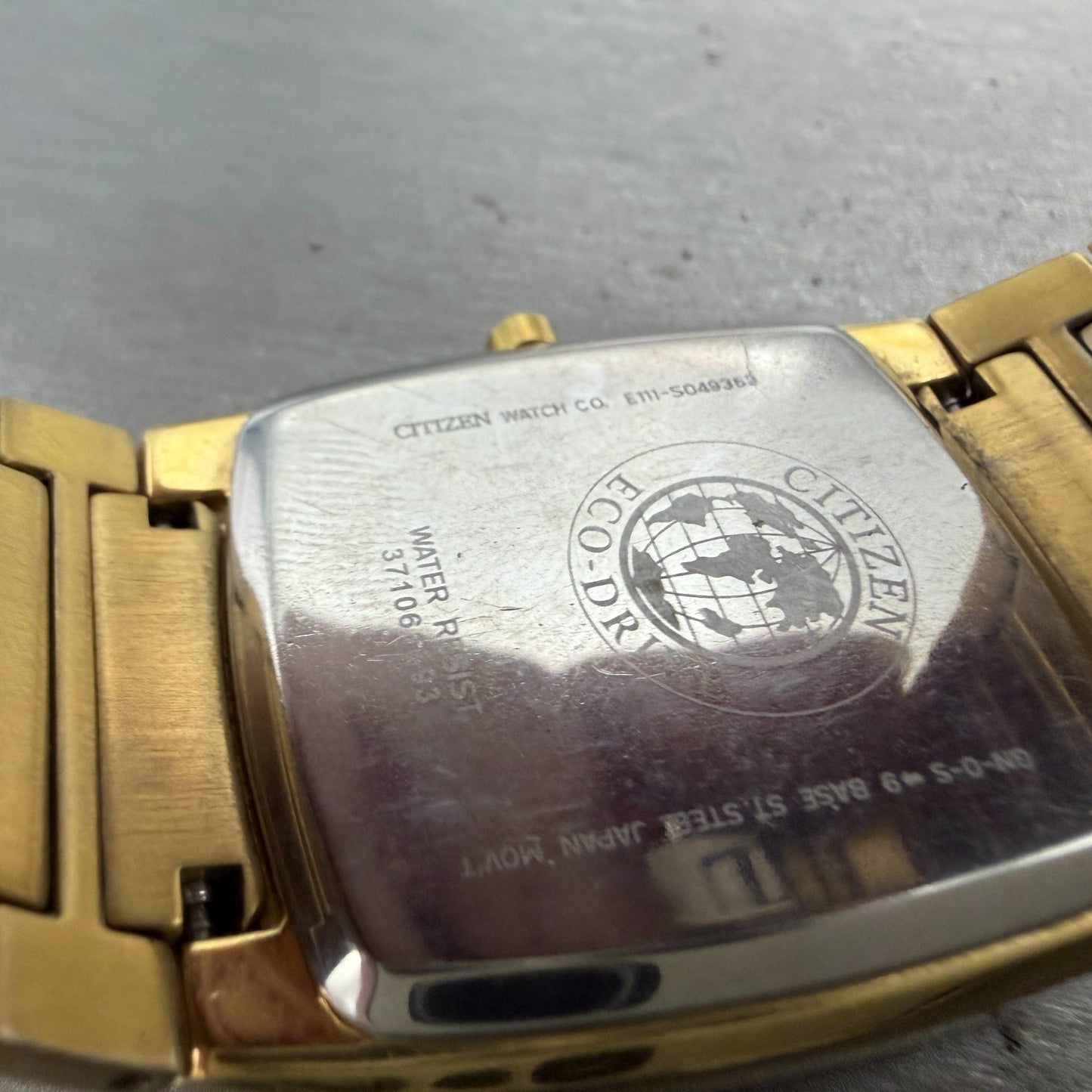 Citizen Eco-Drive Tank Watch Men 31mm Black Dial Gold Tone Date E111-S049369 Run9