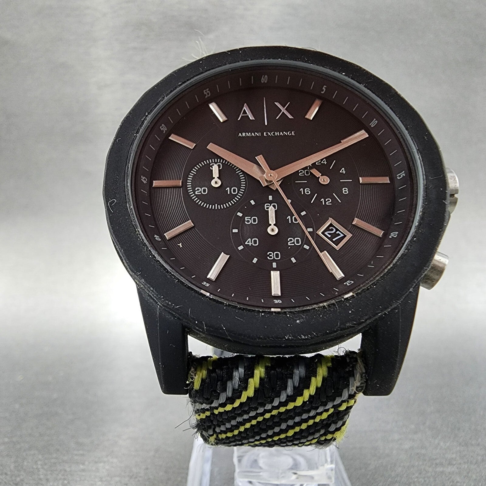 Armani Exchange black analog watch with chronograph, nylon strap, and date display