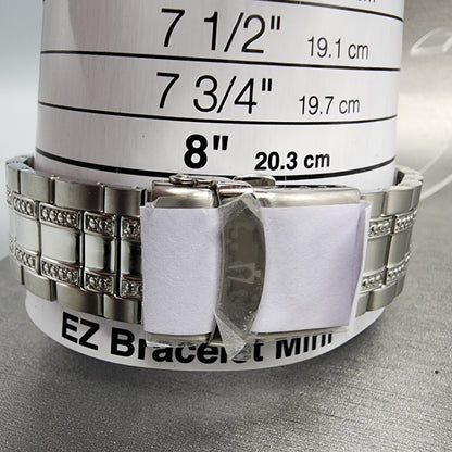 Stainless steel bracelet on wrist sizing tool showing 8 inch size marker, jewelry measuring guide