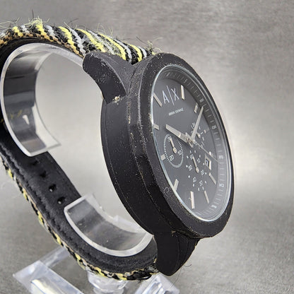 Armani Exchange black analog watch with textured black and yellow fabric strap on display