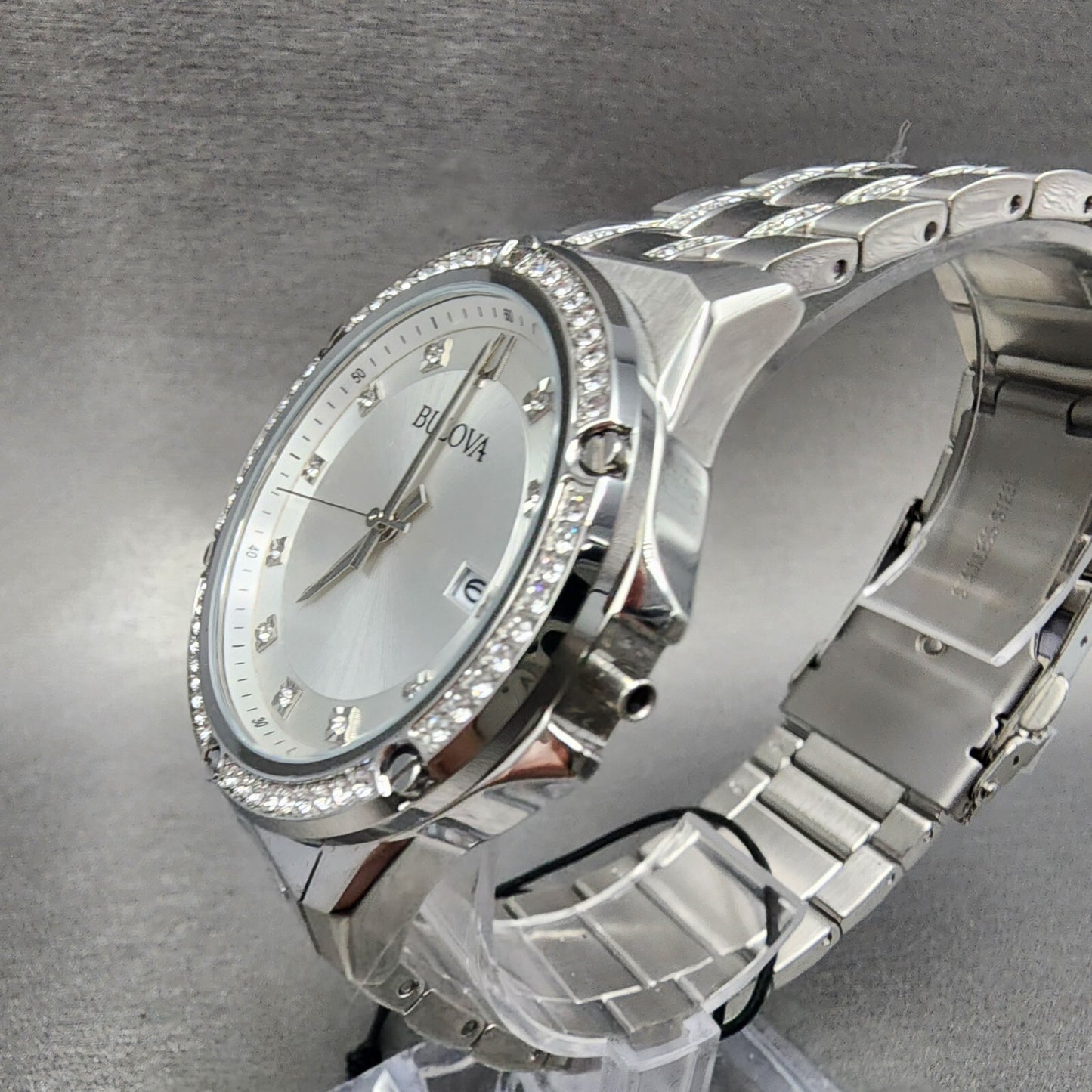 Bulova silver stainless steel diamond bezel watch with silver dial on gray background