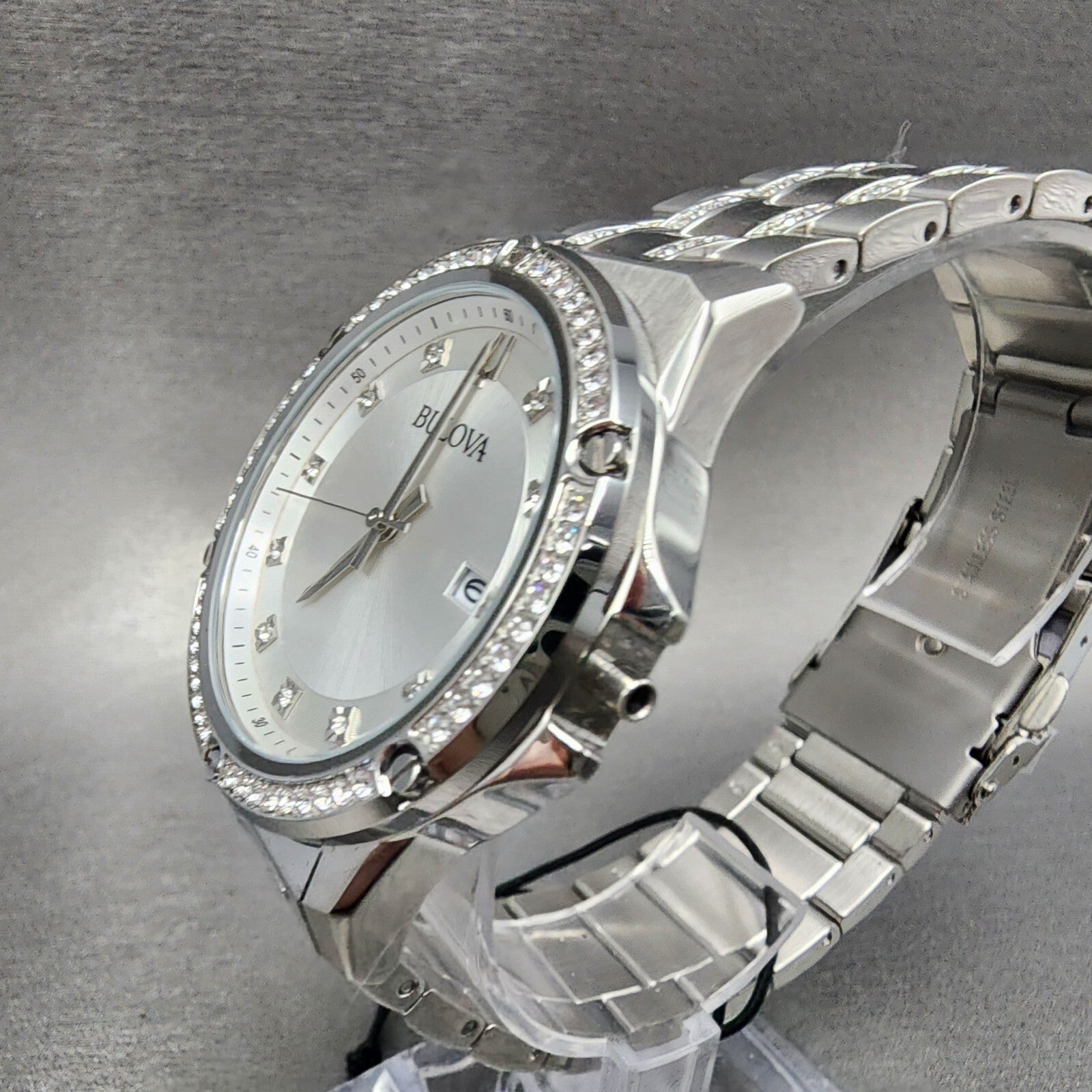 Bulova silver stainless steel diamond bezel watch with silver dial on gray background